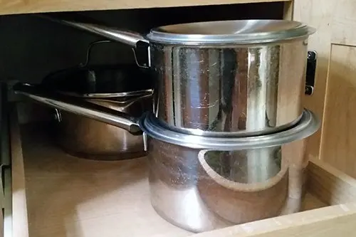 Stacked Pans in Kitchen Cabinet